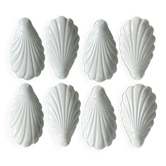 Set of white porcelain ramekins, ribbed shell shape.