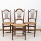 3 wooden and straw chairs, decorated with a sheaf of wheat.