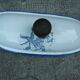 Old wall fountain in enamelled sheet metal decorated with blue flowers on a white background