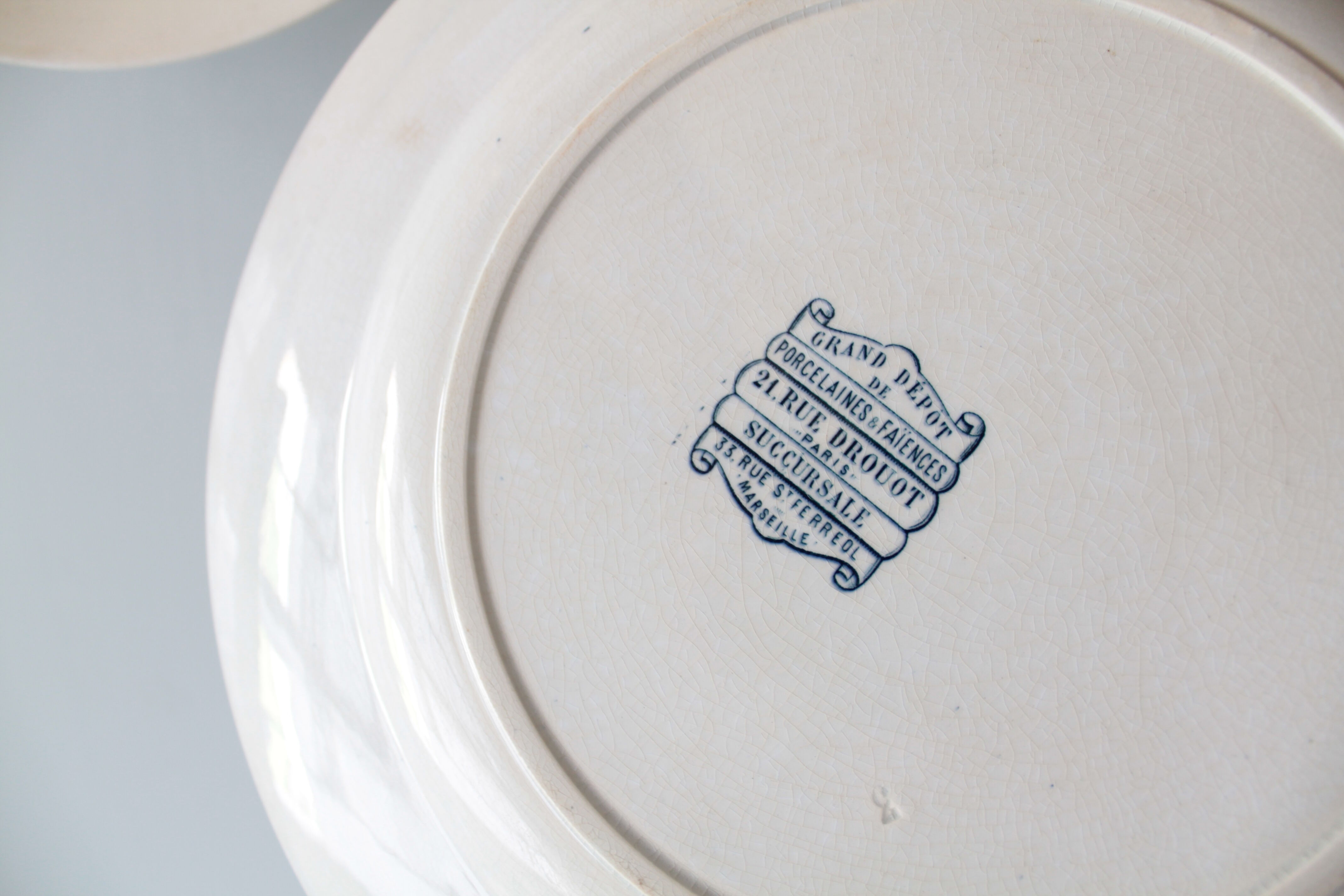 Old dish of opaque porcelain on ground transfer service