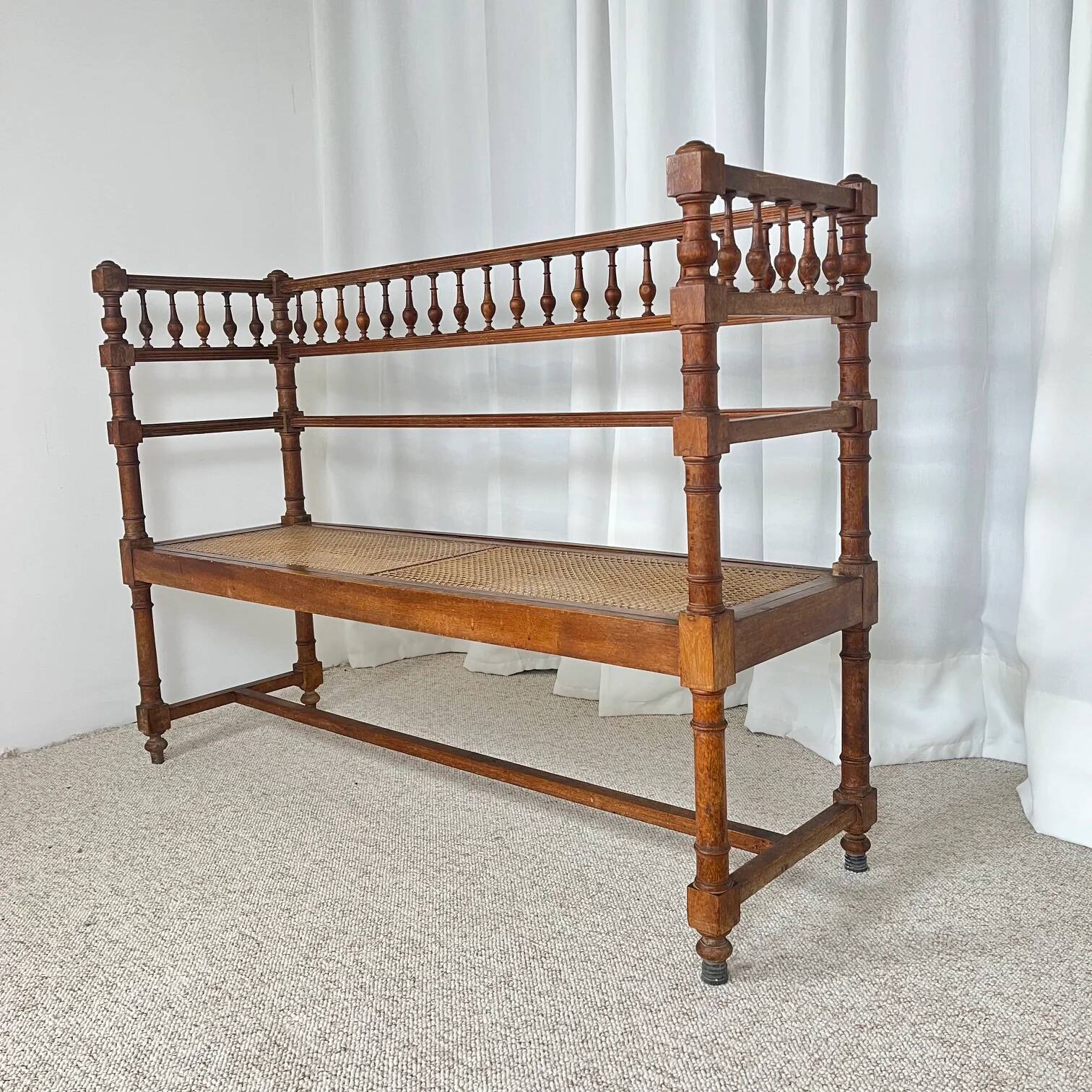 Antique banquette in Louis XIII style, turned wood with caning, late 19th to early 20th century.