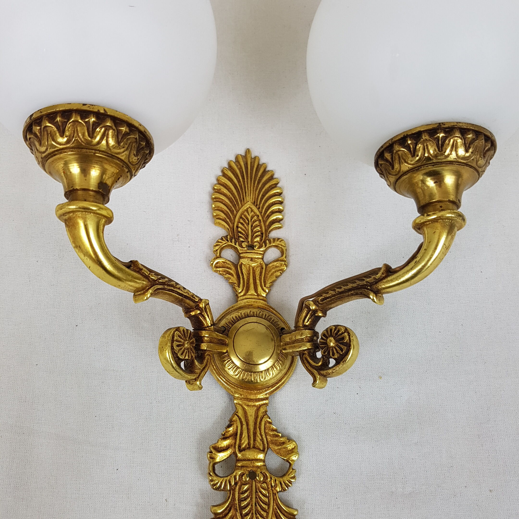 Wall light in gilded bronze and opaque glass globe