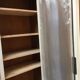 Bookcase 2 painted in ochre and cream mesh doors beginning 20 th