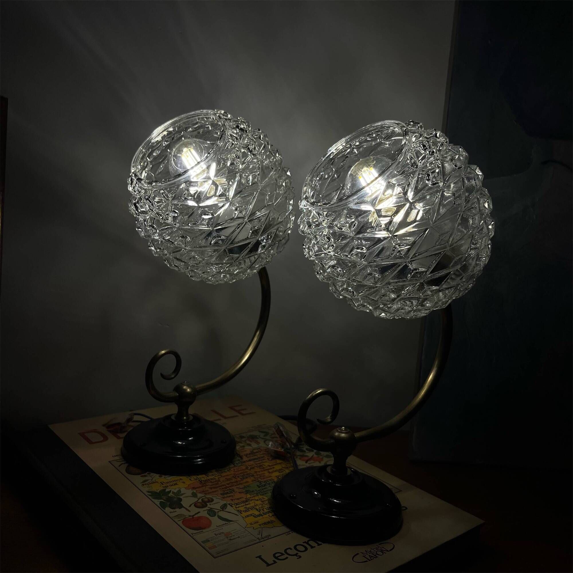Pair of antique wall sconces with swan necks and glass globes.