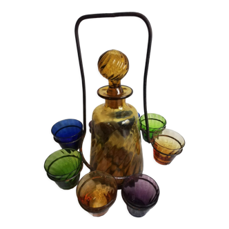 Old Italian alcohol decanter and its colorful glasses