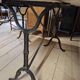 Pair of bistro tables in marble and cast iron.