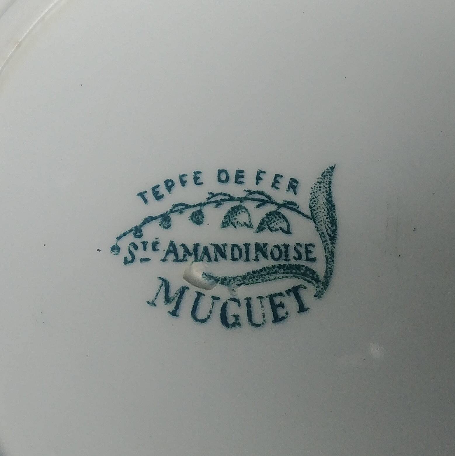 Set of three iron earthenware plates from the St Amandinoise earthenware factory, lily of the valley model.