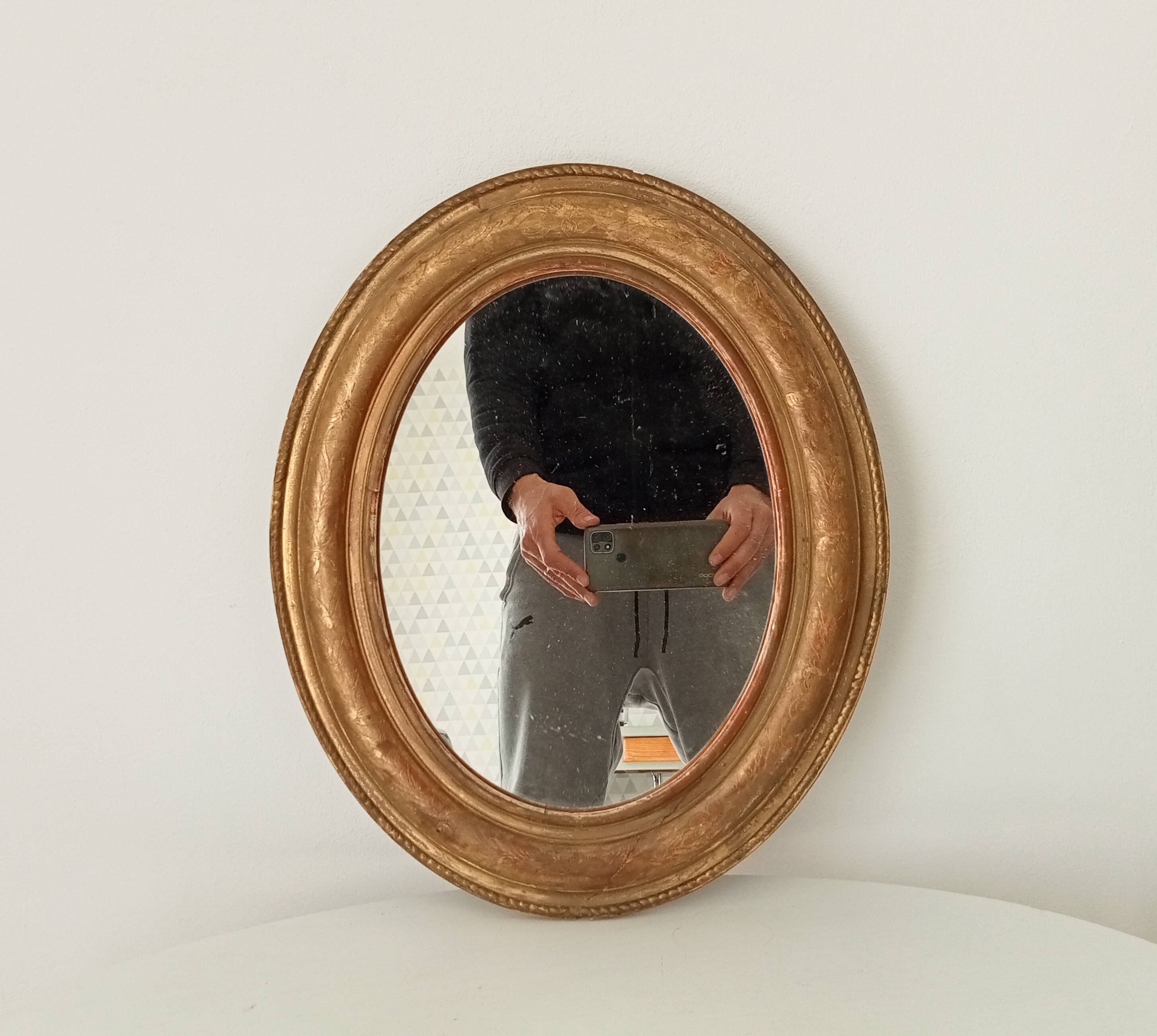 Louis Philippe 19th century oval gilded mirror in wood and stucco