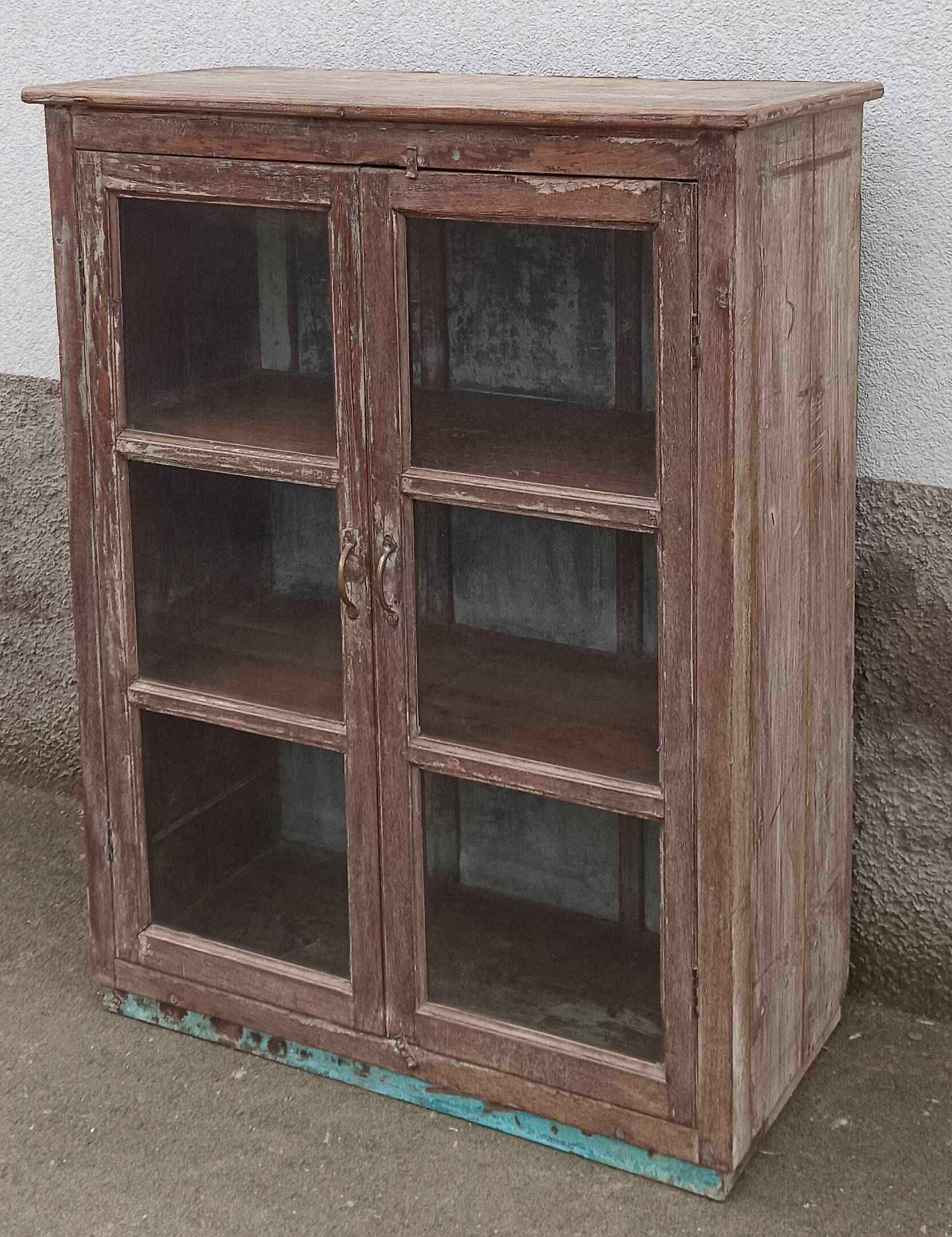 Old glazed wooden cabinet with metal bottom