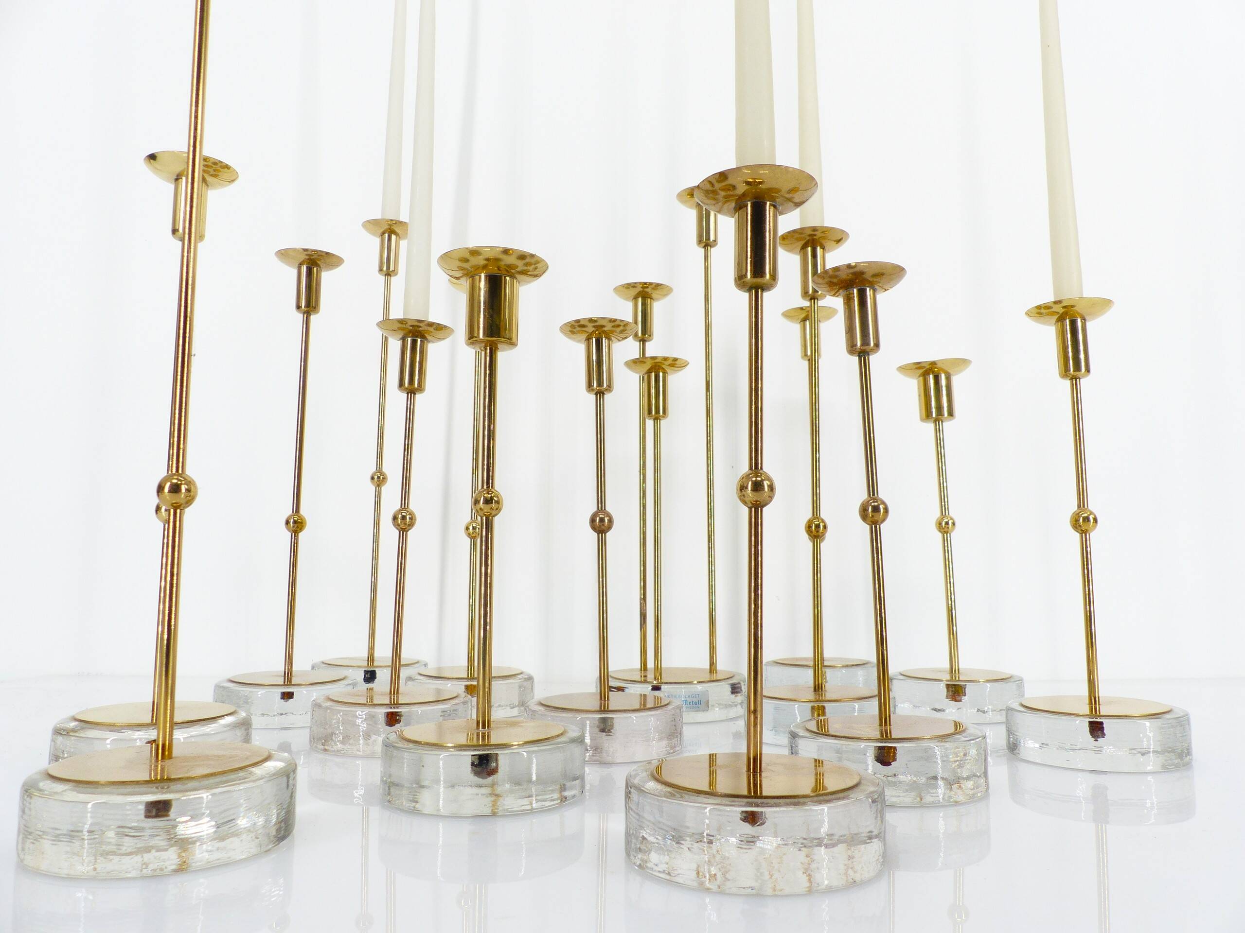 Set of 15 Scandinavian candle holders in brass and glass, Gunnar Ander, Ystad Met
