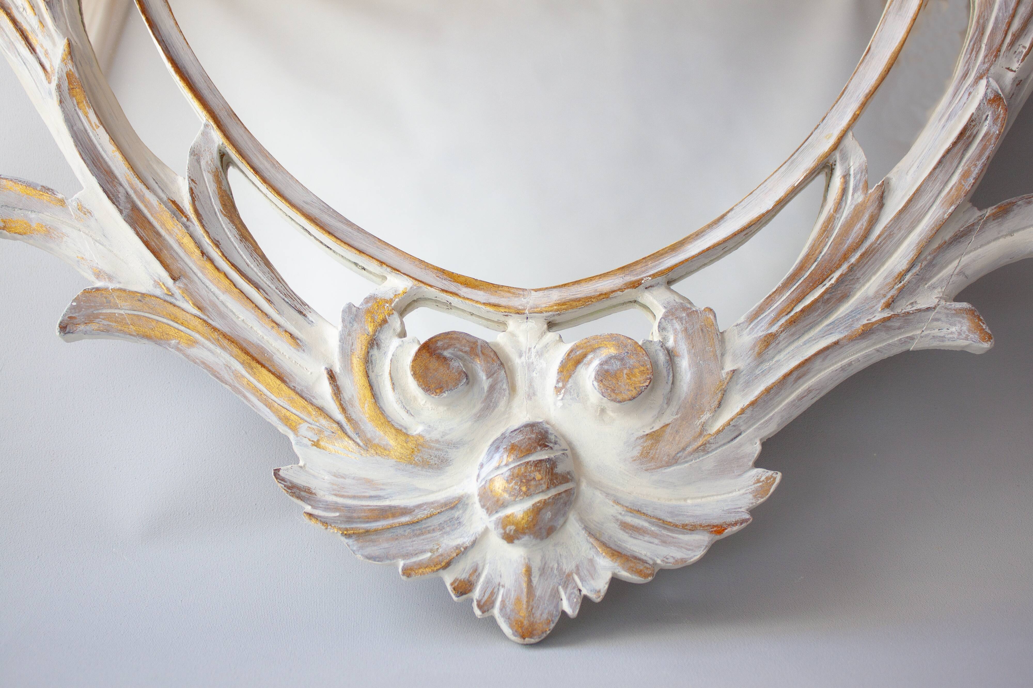 Antique oval mirror carved in wood.