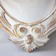 Antique oval mirror carved in wood.