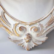 Antique oval mirror carved in wood.