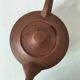 Japanese teapot in red clay engraved with integrated filter.
