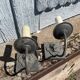 Two lion head wall sconces in tin.