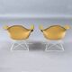 Paire de chaises coque LAR Eames pour Herman Miller avec des coussins en Naugahyde jaune.