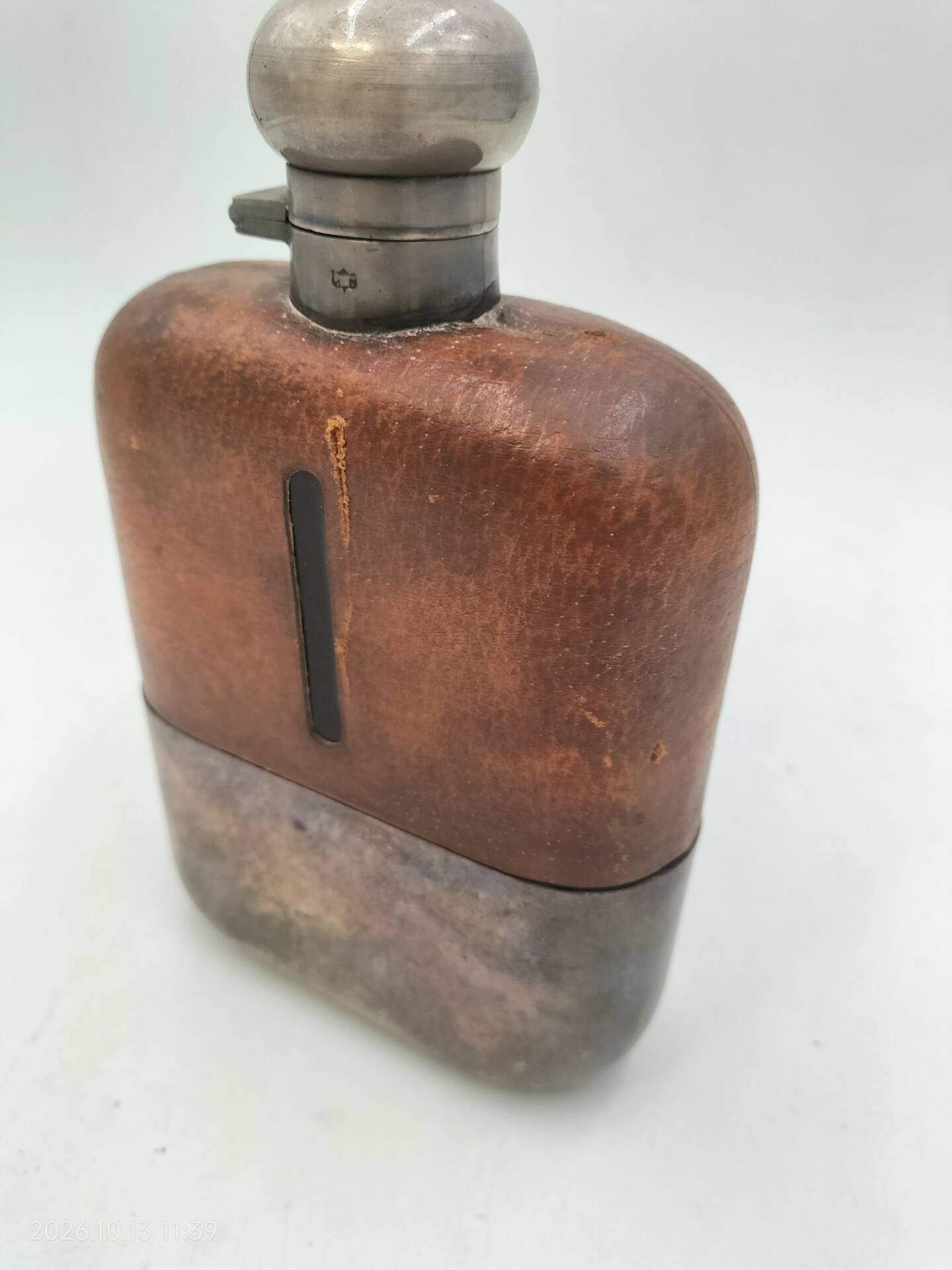 Silver-plated metal flask with leather and glass
