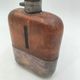 Silver-plated metal flask with leather and glass