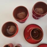Red enamelled terracotta: cups, saucers, glasses