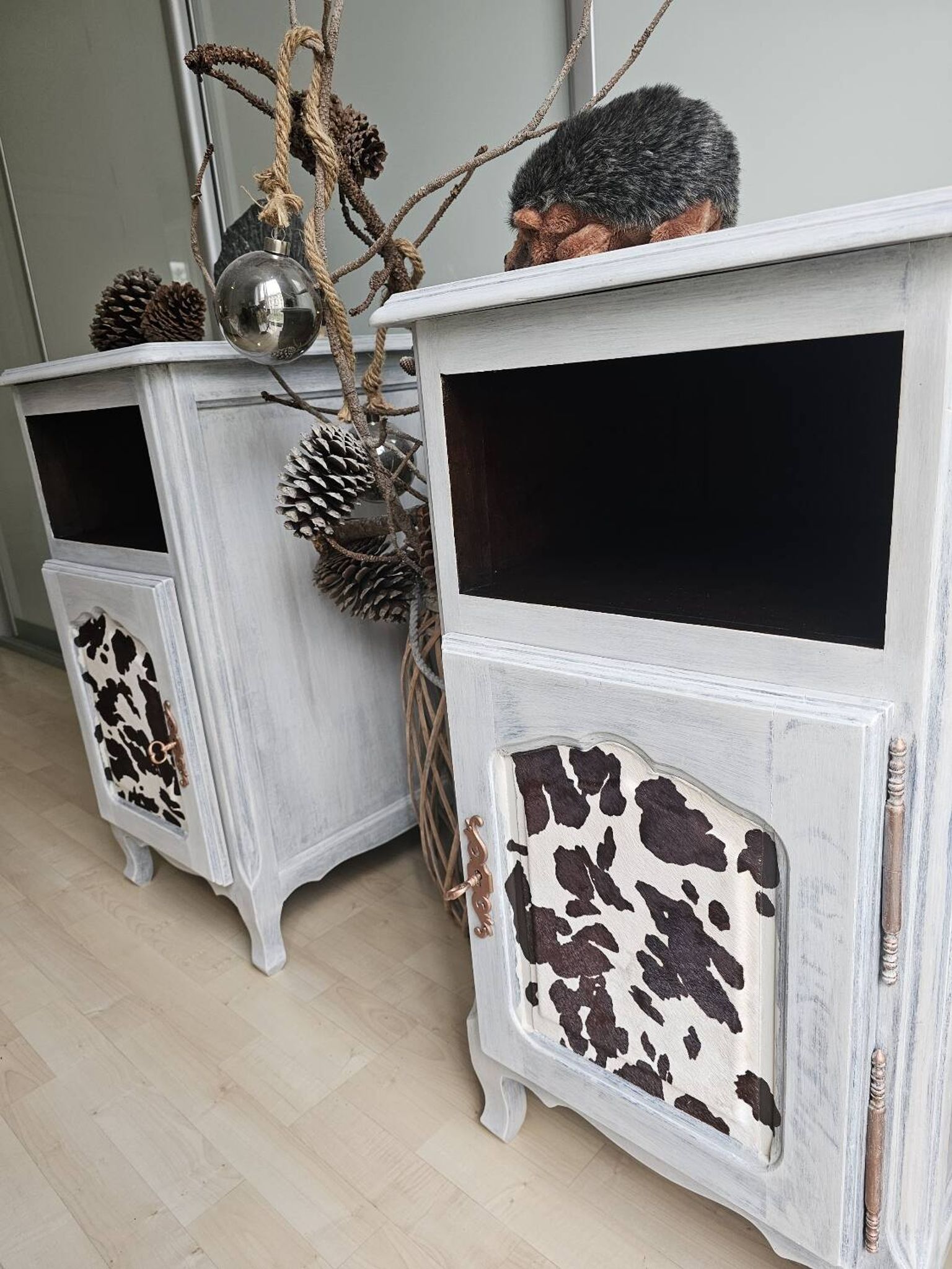 Two solid wood bedside tables with calfskin decoration.
