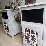 Two solid wood bedside tables with calfskin decoration.