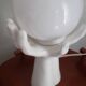 70s lamp two hands embrace an opaline globe