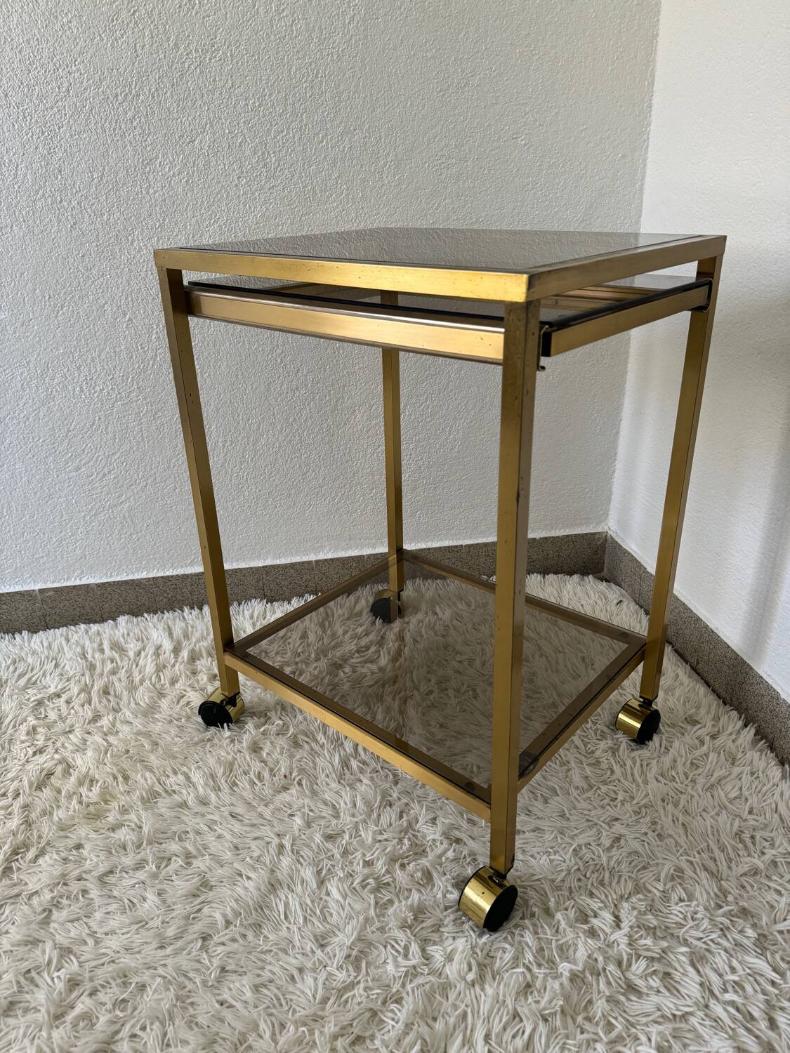 Brass rolling trolley with smoked glass from the 70s
