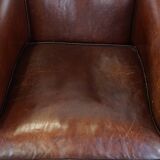 Sheepskin club armchair, correct finishing with decorative nails