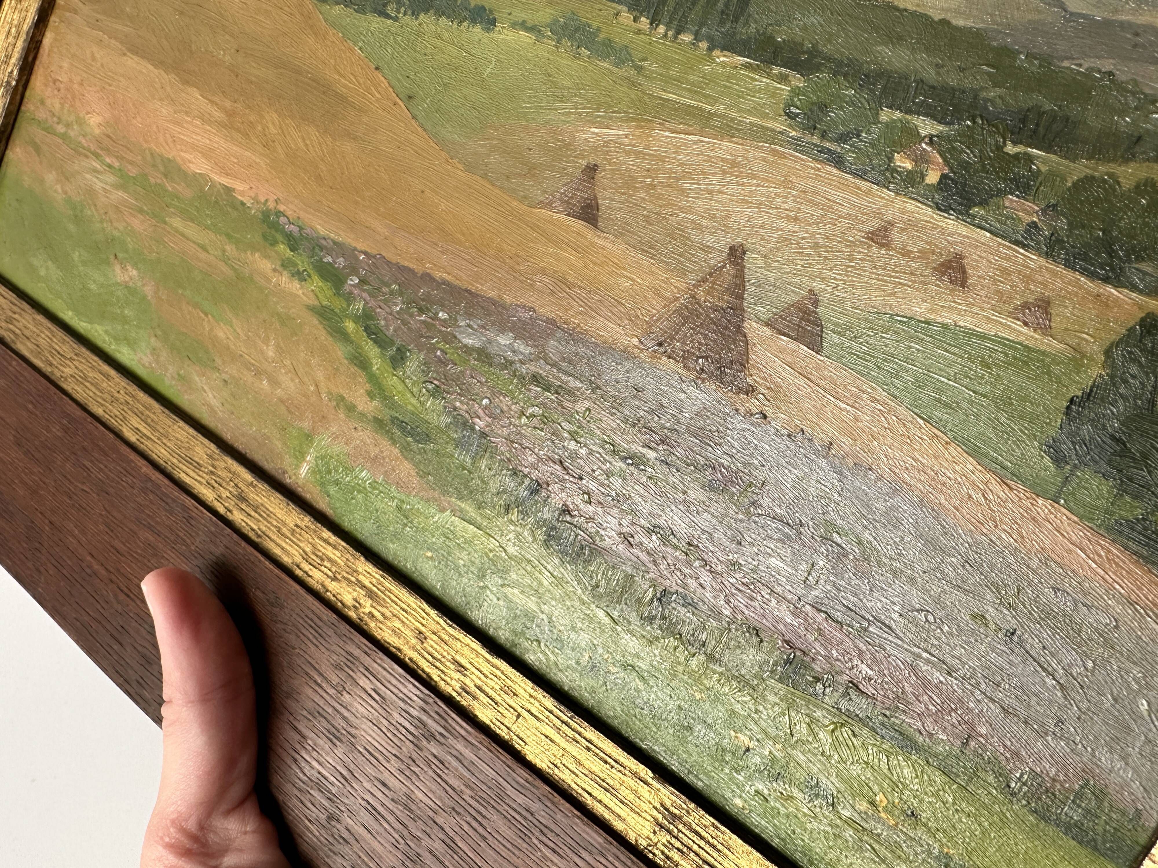 Old oil painting of a landscape on panel from 1920, haystacks.