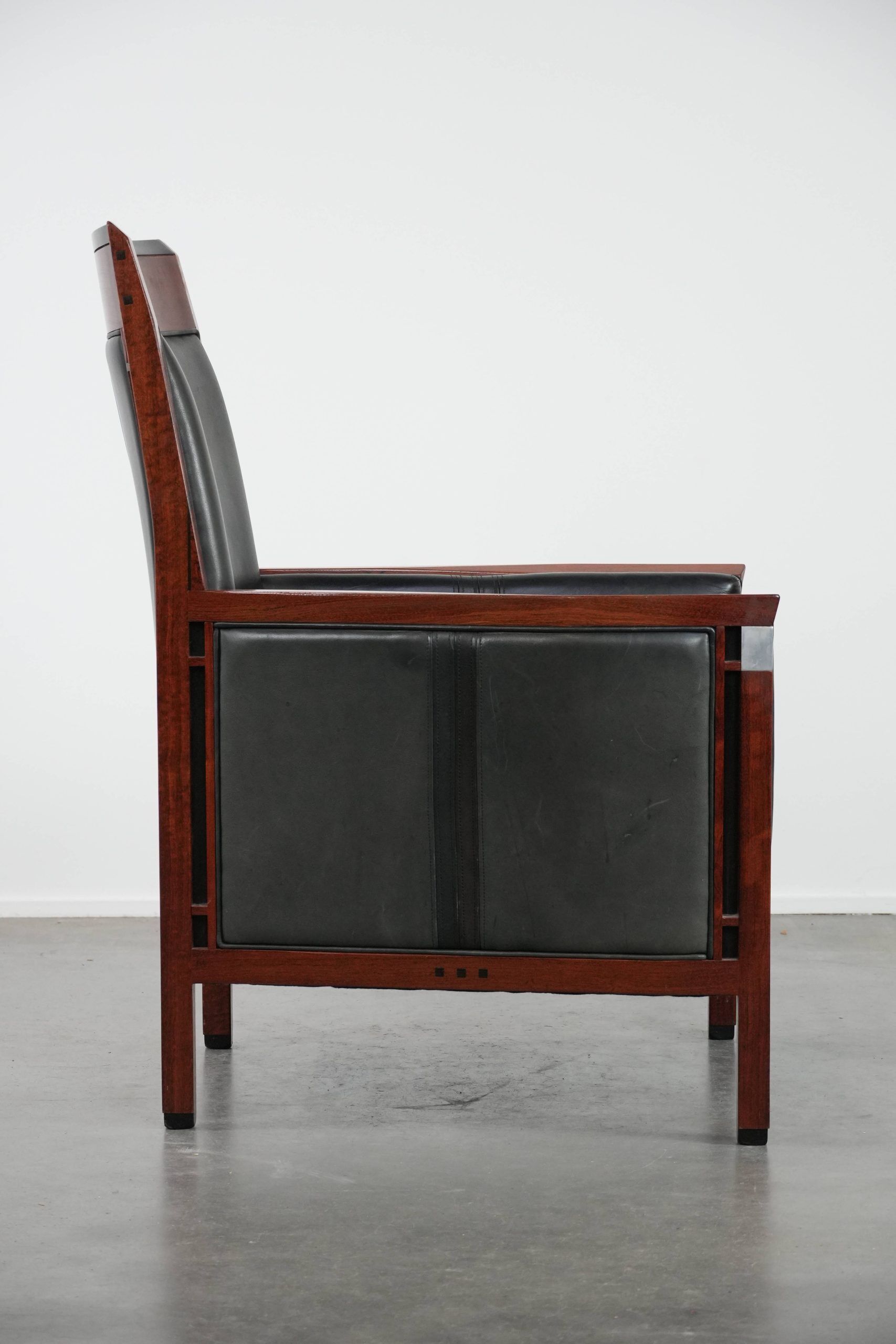 Black Art Deco cowhide leather and wooden design armchair with a high back