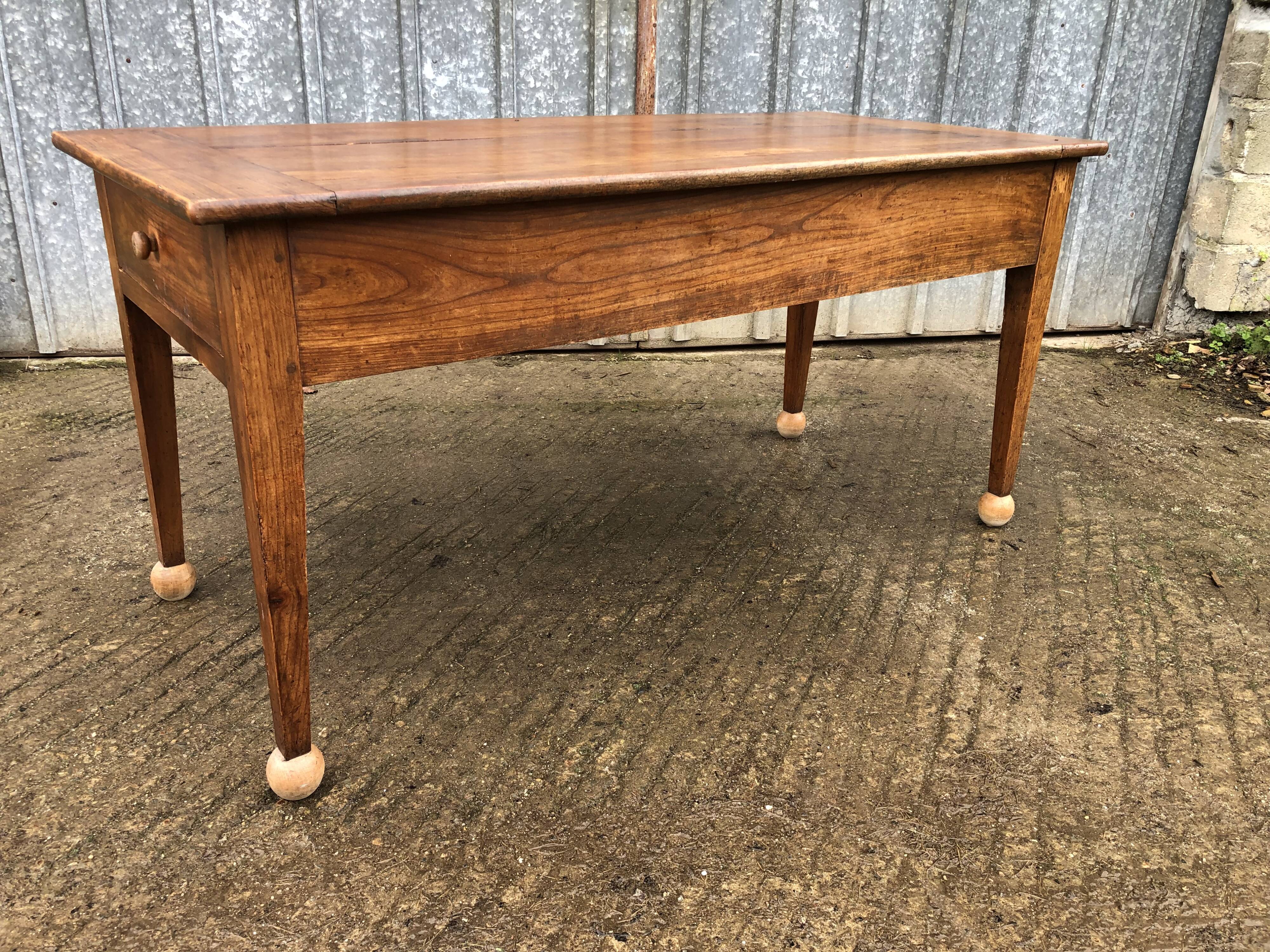 Antique solid cherry farmhouse table with 2 end drawers and 1 pull-out.