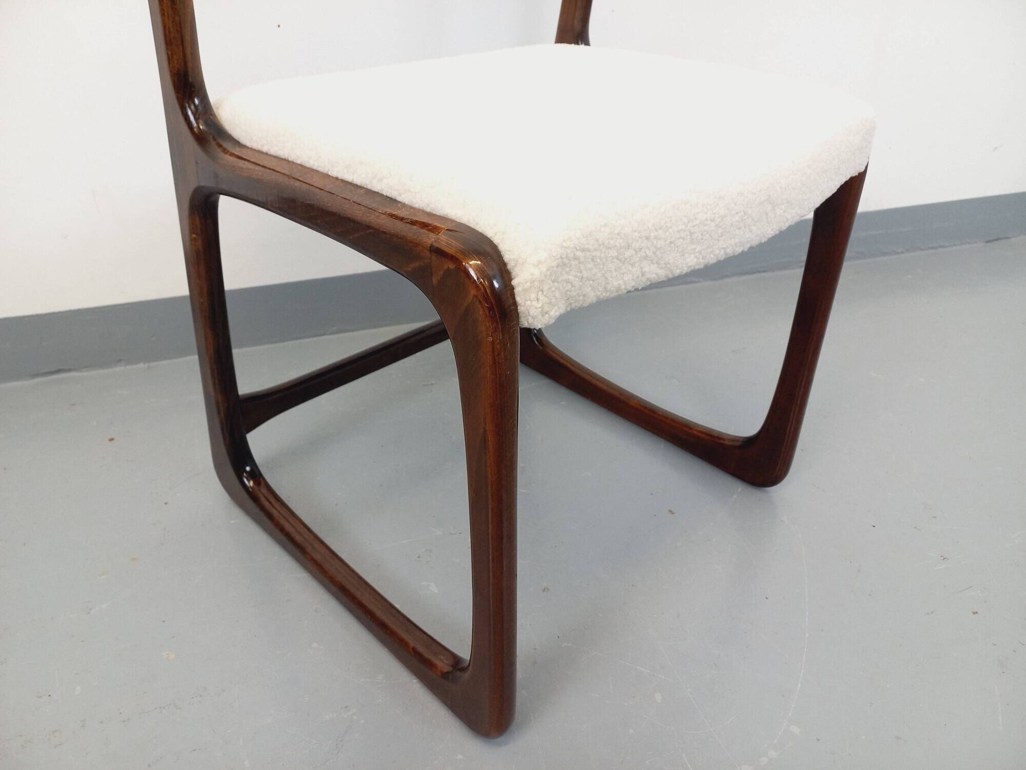 Vintage sled chair by Baumann in wood and boucle fabric.
