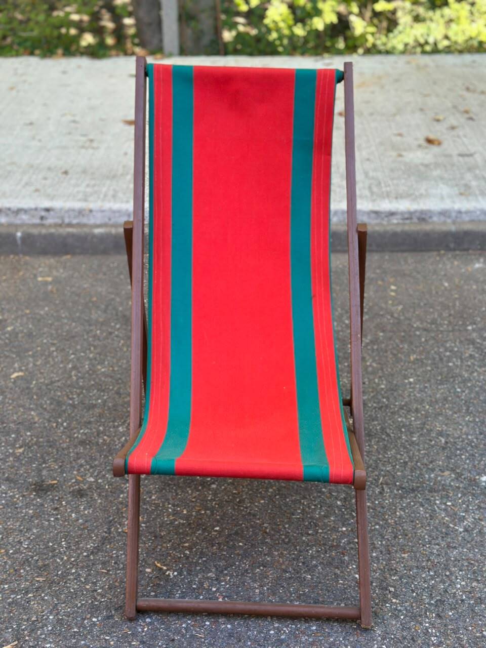 Vintage folding wooden deck chair with red and green striped canvas from the 1970s.