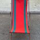 Vintage folding wooden deck chair with red and green striped canvas from the 1970s.