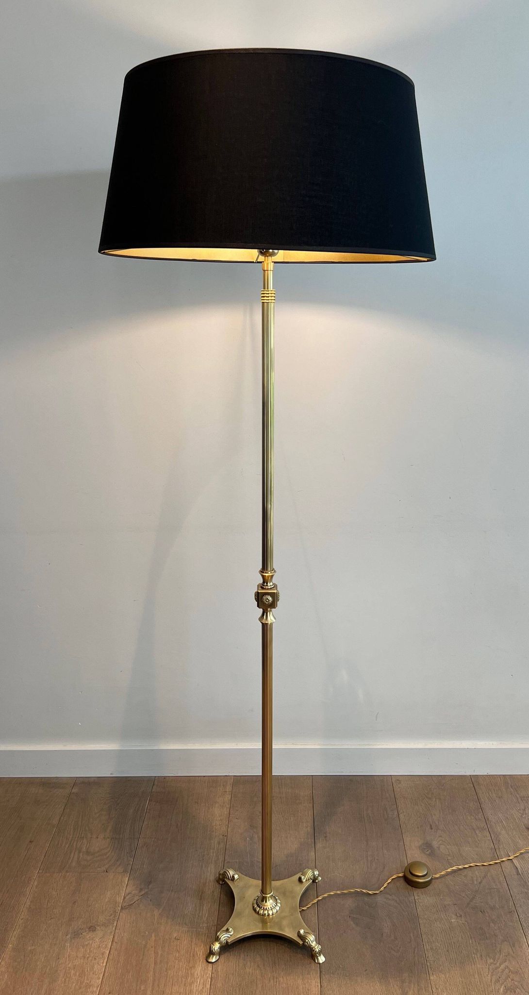 Neoclassical brass floor lamp with claw feet from Maison Jansen.