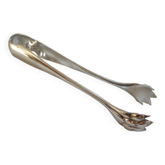 Christofle silver-plated sugar tongs with lion's paw feet.