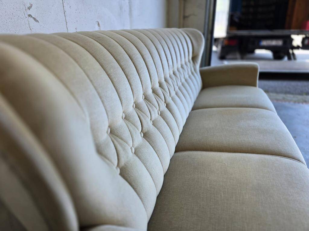 Vintage beige sofa with fringes