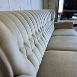 Vintage beige sofa with fringes