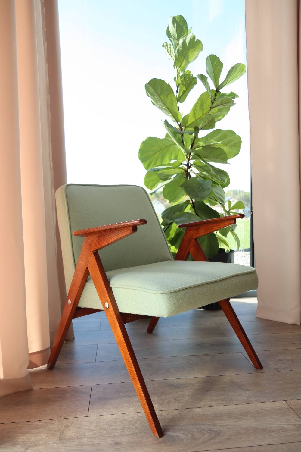 Vintage armchair in mint green wool, mid-century modern design.
