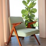 Vintage armchair in mint green wool, mid-century modern design.