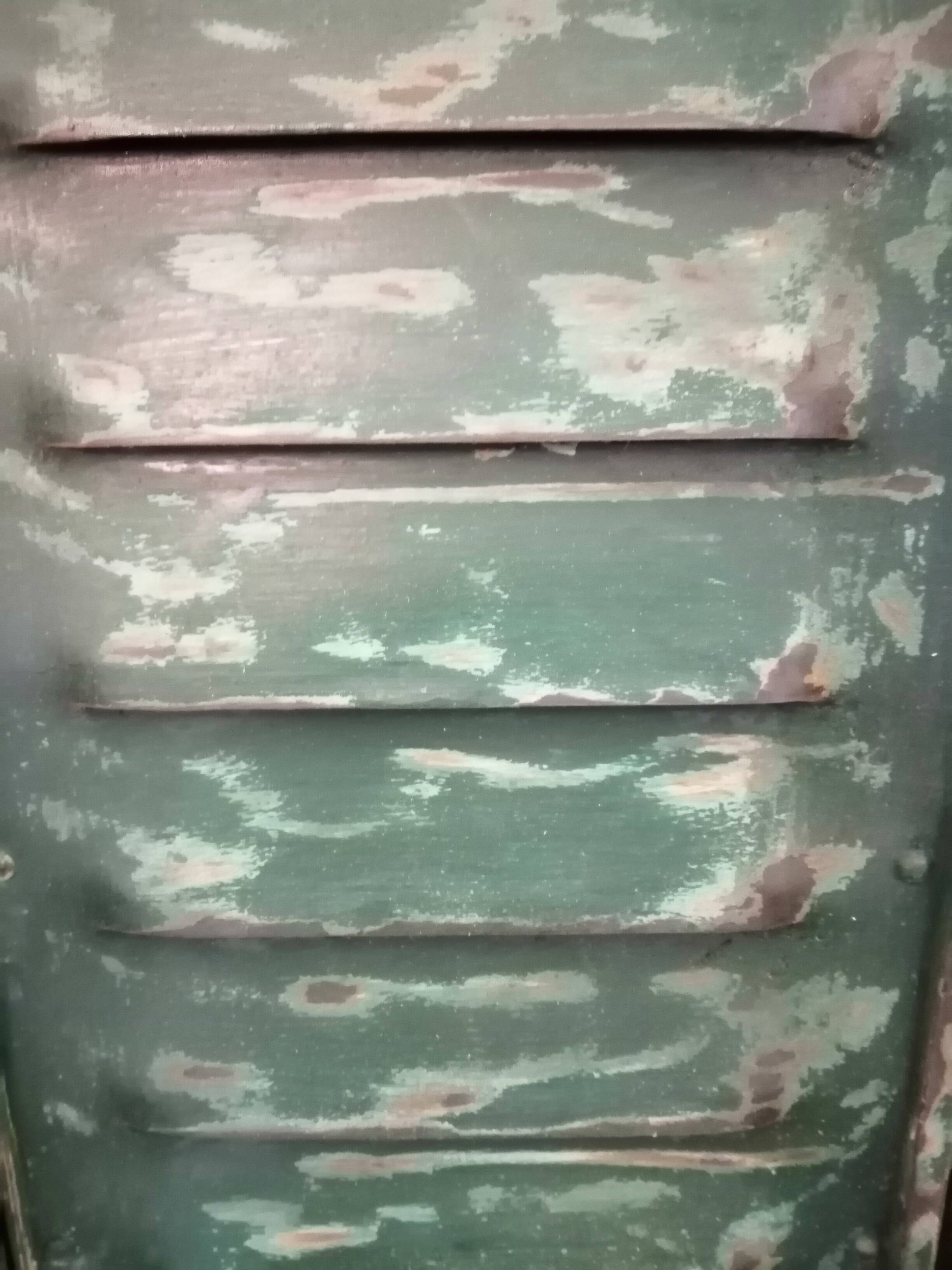 Lot of old green shutters in 4-part iron screen headboard