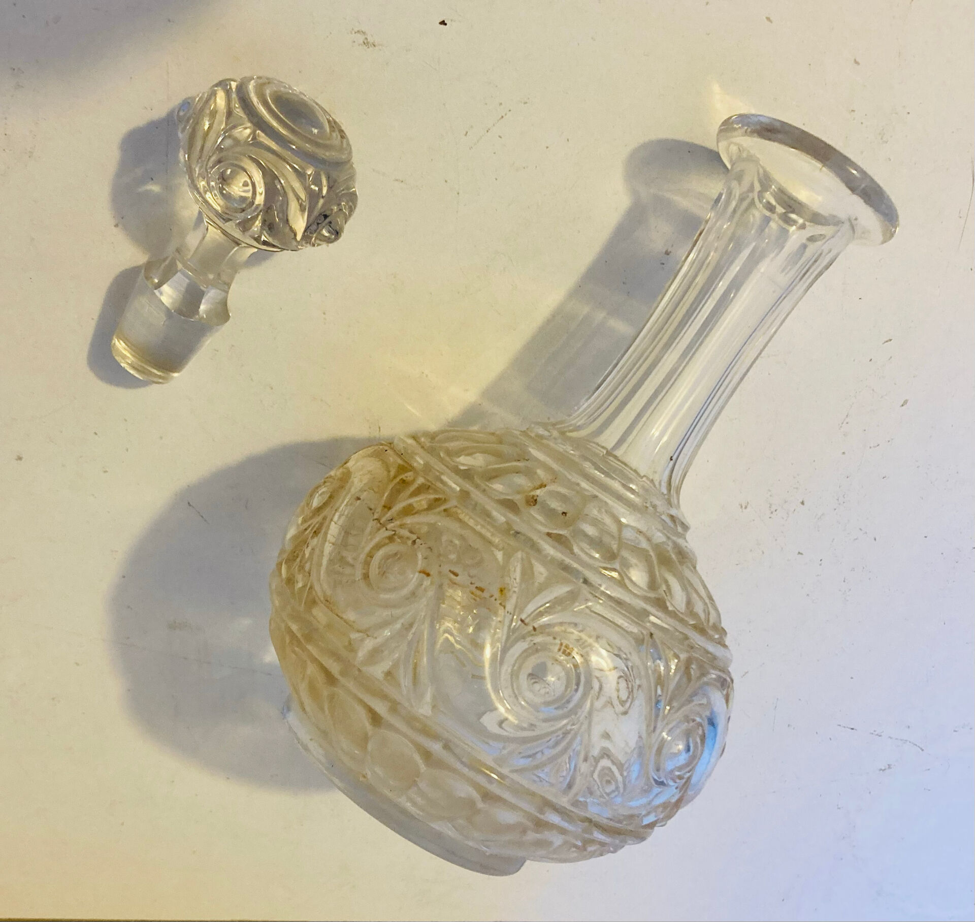 19th-century liqueur carafe in glass adorned with relief patterns.