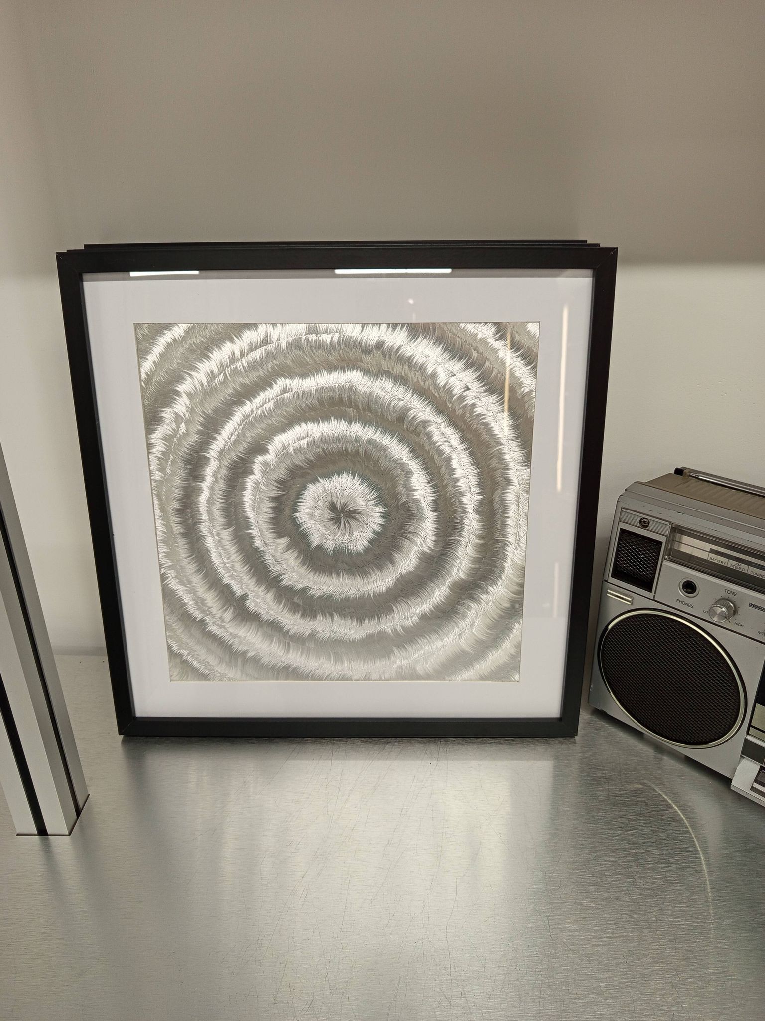 a Kinetic Op Art Aluchromy under glass frame.