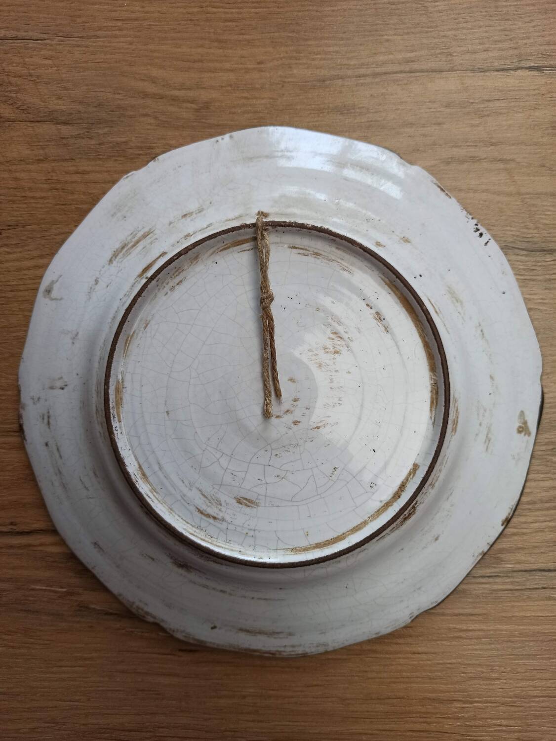 Eastern earthenware plate decorated with a ripe poppy flower