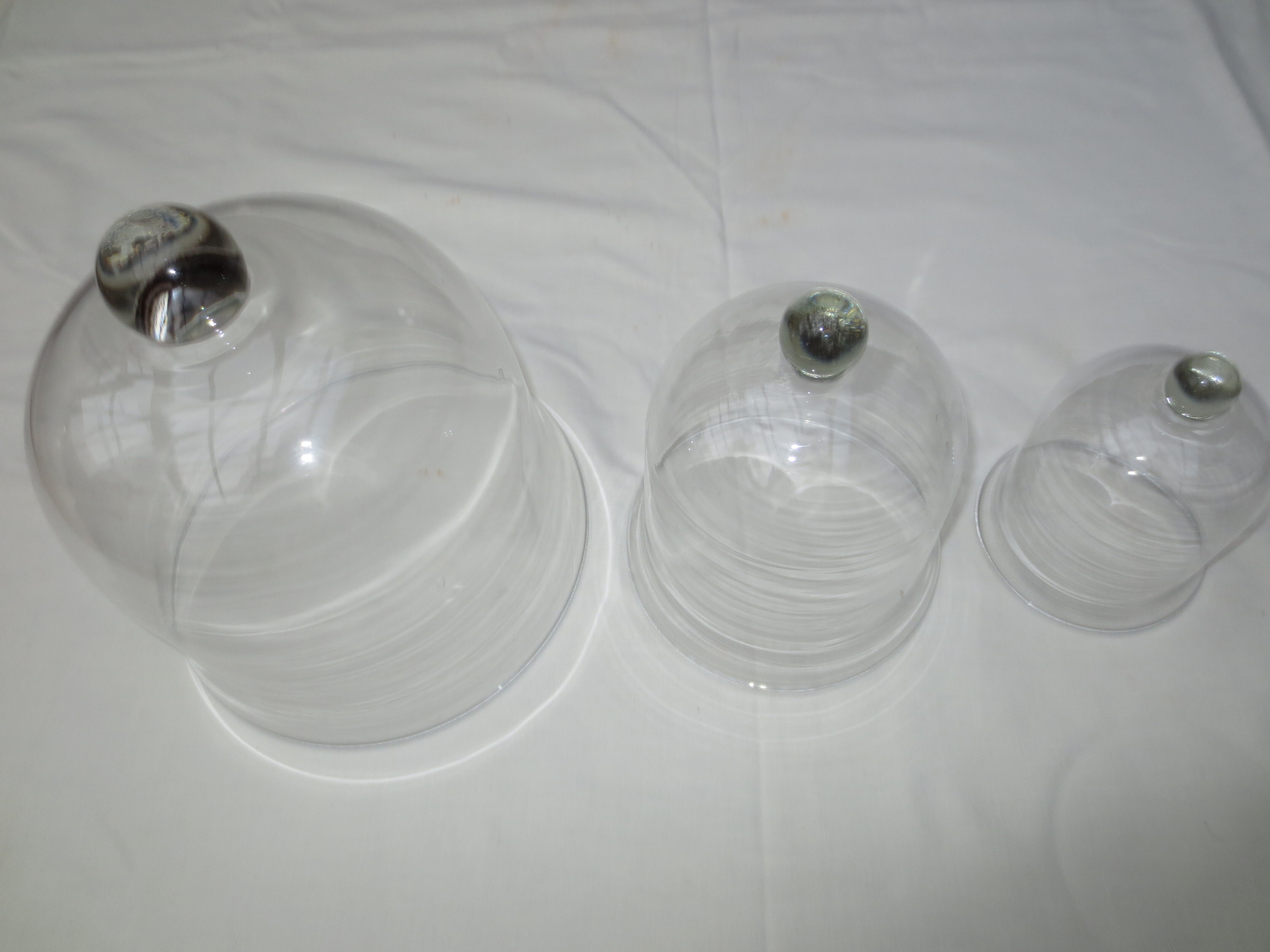 trio of old bells in transparent glass