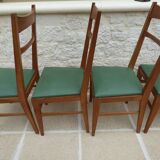 6 modern chairs with banded backs and green faux leather seats