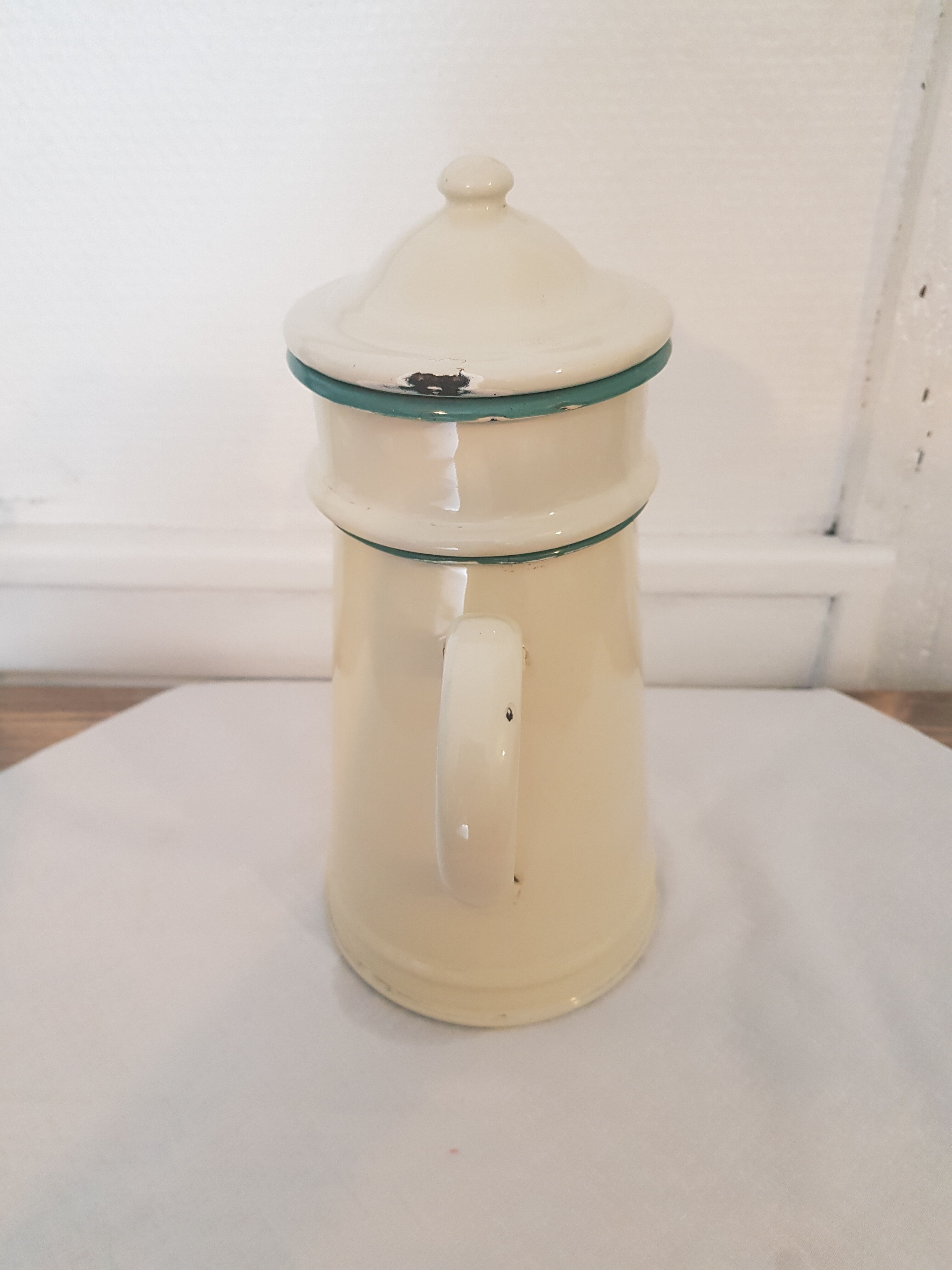 Old pale yellow enamelled coffee maker with filters
