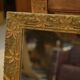 19th-century mirror in wood and stucco with floral decoration.