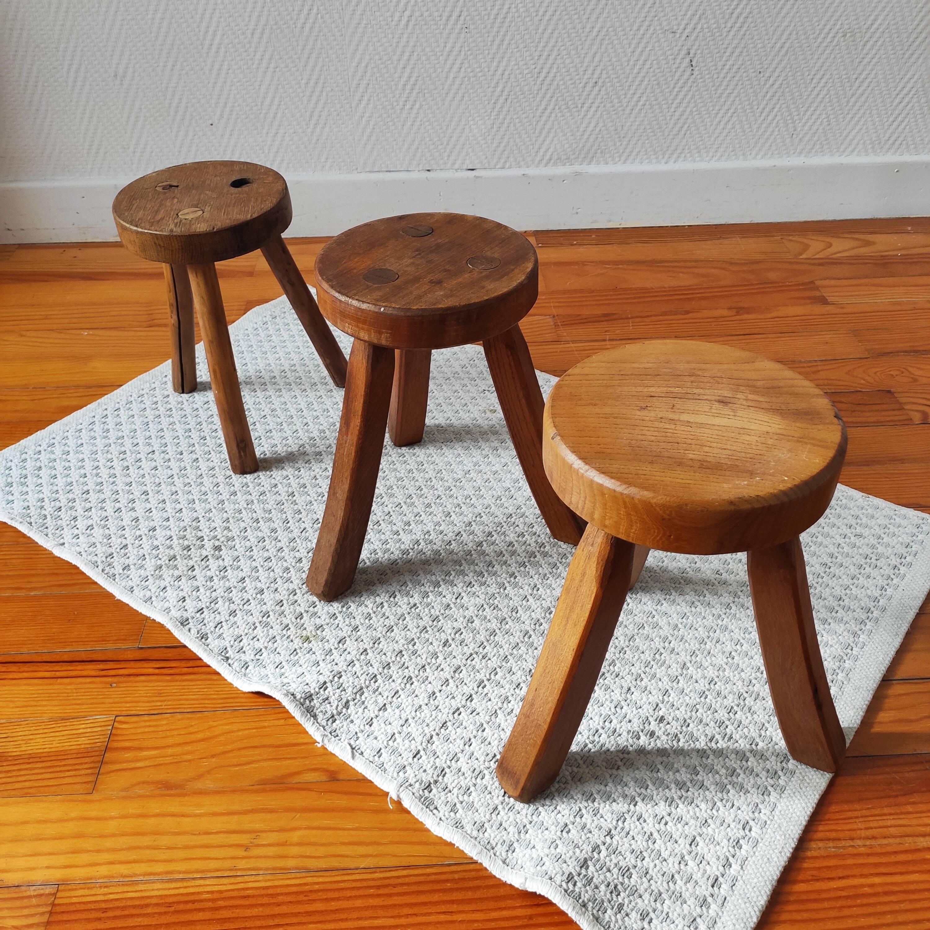 3 wooden tripod stools