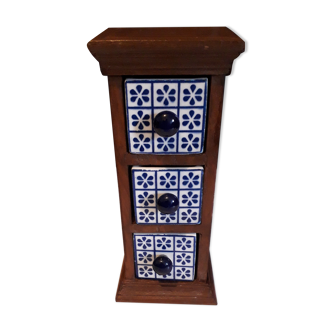 Storage in the form of a small wooden cabinet, with 3 ceramic drawers.